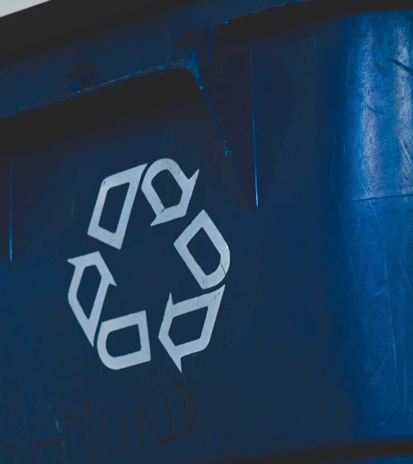 Recycling symbol on a blue container